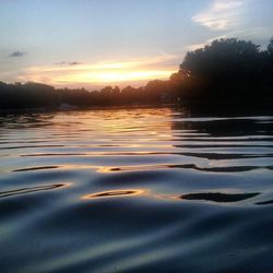 Scenic shot of calm lake at sunset