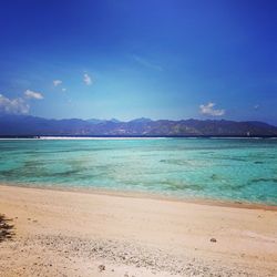 Scenic view of sea against blue sky