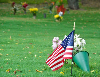 Usa flag and flower pot at cemetery in hawaii.