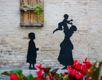 Silhouette of statue against building