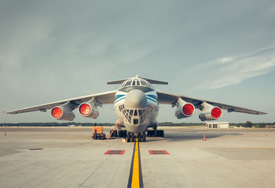 Airplane on runway against sky