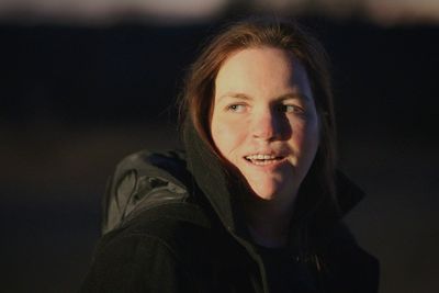 Close-up of smiling woman looking away