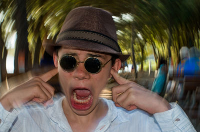 Close-up portrait of young woman wearing sunglasses