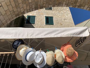 Low angle view of clothes hanging on wall of building