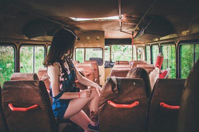 Side view of girl on bus