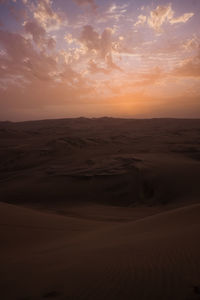 Scenic view of desert against sky during sunset