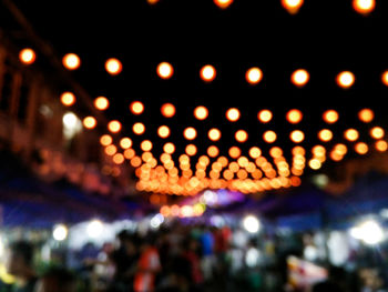 Low angle view of illuminated lanterns hanging at night