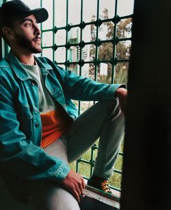 Young man looking at the window