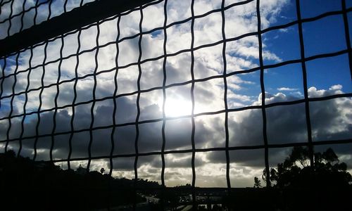 Low angle view of modern building against cloudy sky