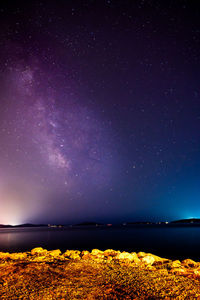 Scenic view of lake against sky at night