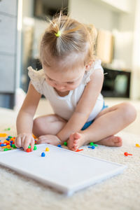 Full length of girl playing with toy at home