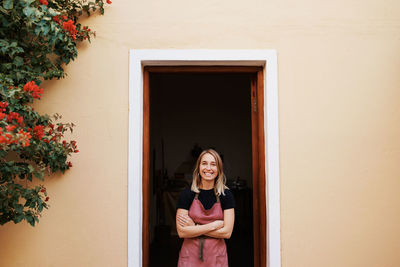 Portrait of woman standing at door