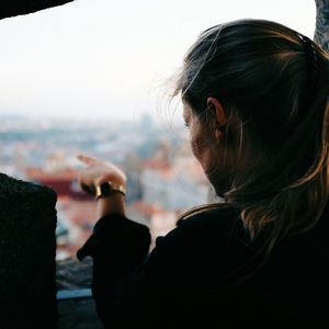 Close-up of woman hand against sky