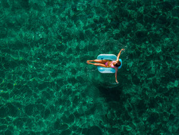 High angle view of man swimming in sea