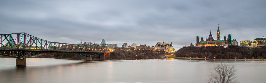 View of bridge over river against cloudy sky