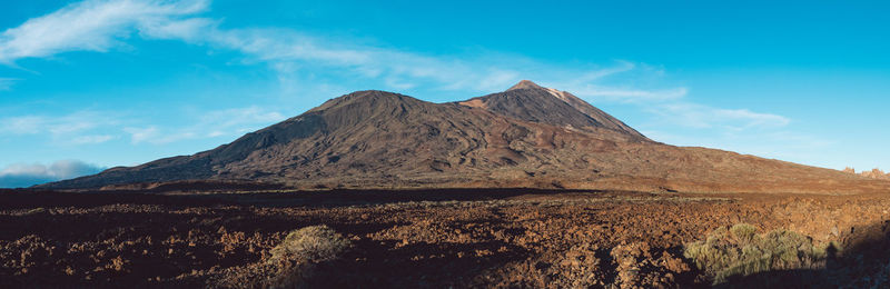 Scenic view of volcanic mountain against sky