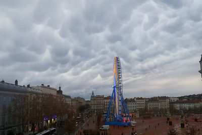 Panoramic view of people in city against sky