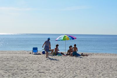 People enjoying at sandy beach 