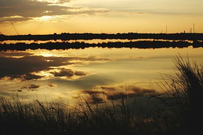 Reflection of clouds in lake at sunset