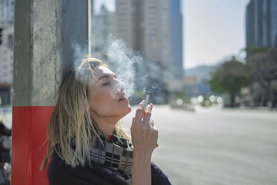 Young woman smoking cigarette