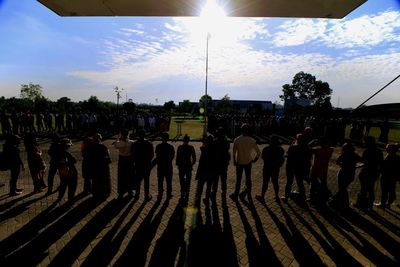 Group of people against sky