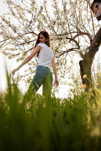 Young woman standing amidst plants