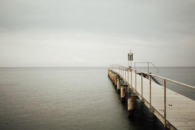 Pier over sea against sky