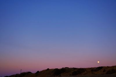 Scenic view of landscape against clear sky at night