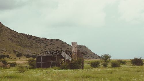 Old building on field against sky