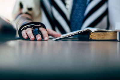 Cropped hand of woman holding book