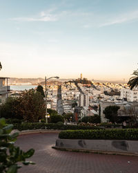 Buildings in city against sky during sunset