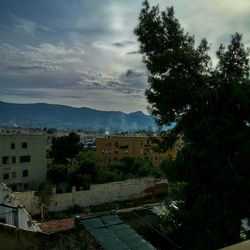 Residential buildings against cloudy sky