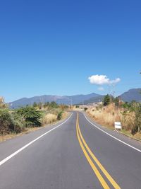 Empty road along countryside landscape