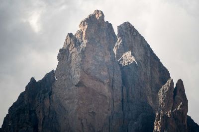 Low angle view of rocky mountains against sky