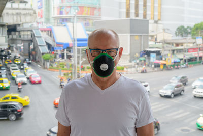 Portrait of man on road in city