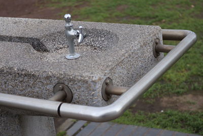 Close-up of faucet on railing
