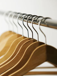 Close-up of coathangers hanging on rack