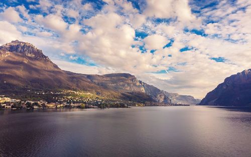 Scenic view of sea and mountains against sky