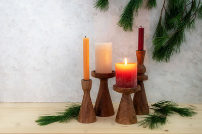 Close-up of illuminated candles on table