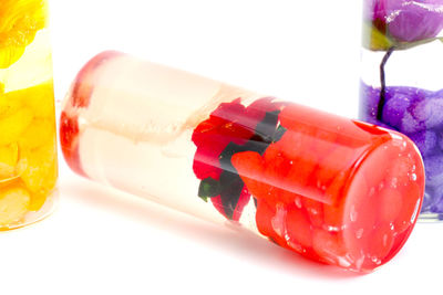 Close-up of drink on table against white background