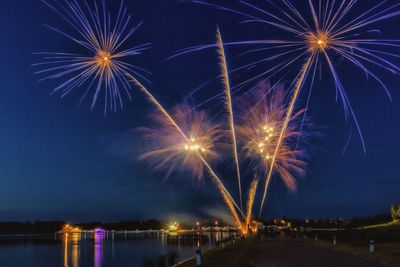 Low angle view of firework display at night