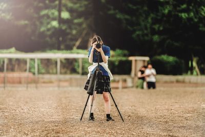 Girl photographing while standing on land