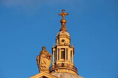 Low angle view of statue against blue sky