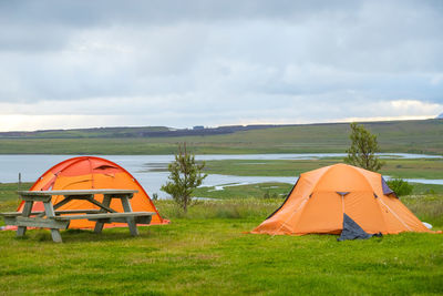 Tent on field against sky