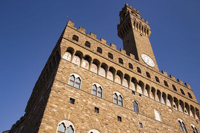 Low angle view of historical building against blue sky