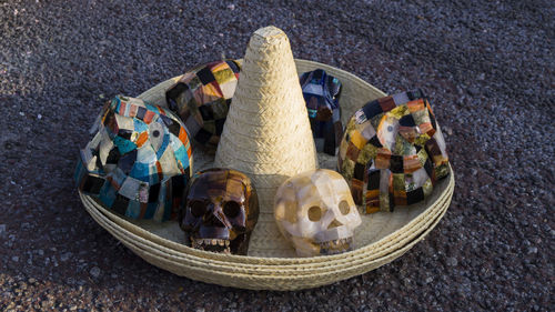 High angle view of artificial skulls on sombrero