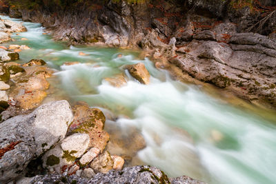 High angle view of stream flowing through rocks