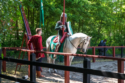 Horse cart on railing against trees