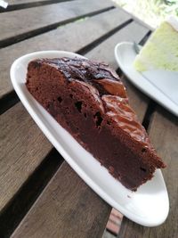 Close-up of chocolate cake served in plate on wooden table