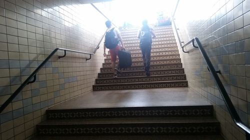 Low angle view of people walking up stairs